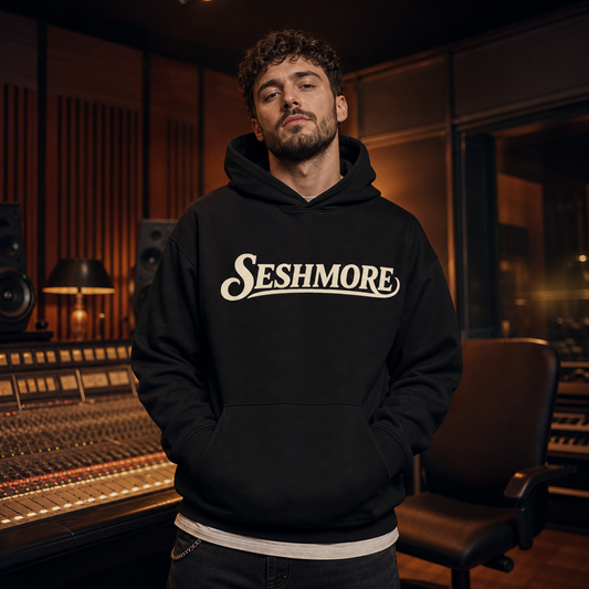 Male model wearing black Studio Sessions Getting Ready hoodie in a recording studio